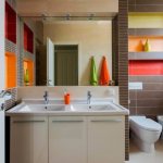 Double sink in front of a large mirror